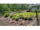 Landscaped backyard with mature trees, rock drainage, and stone staircase at 287 Flower Farm Dr, Acworth, GA 30101