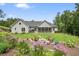 Backyard with lush lawn, inviting fire pit, screened-in porch, and mature landscaping at 287 Flower Farm Dr, Acworth, GA 30101
