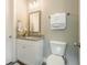 Neat half-bathroom with modern toilet, vanity, and framed mirror at 287 Flower Farm Dr, Acworth, GA 30101