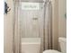 A charming bathroom with tiled shower and decorative curtains and window at 287 Flower Farm Dr, Acworth, GA 30101