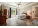 Bright primary bedroom with a trey ceiling, a ceiling fan, and a backyard view at 287 Flower Farm Dr, Acworth, GA 30101