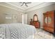 Cozy bedroom with wooden furniture, a ceiling fan, and a backyard view at 287 Flower Farm Dr, Acworth, GA 30101
