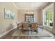 Dining room with a wooden table, six upholstered chairs, and a chandelier above at 287 Flower Farm Dr, Acworth, GA 30101
