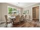 An inviting dining room with hardwood floors, a modern light fixture, and a backyard view at 287 Flower Farm Dr, Acworth, GA 30101