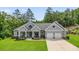 Charming, single-story home with a two-car garage, gray siding, covered porch, and manicured lawn at 287 Flower Farm Dr, Acworth, GA 30101