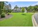 A charming one-story home with gray siding, a covered porch, attached two-car garage, and landscaped lawn at 287 Flower Farm Dr, Acworth, GA 30101