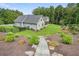 Spacious home exterior with landscaped backyard, stone steps, and manicured lawn at 287 Flower Farm Dr, Acworth, GA 30101
