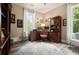 Home office with dark wood desk and cabinets, large window, and circular rug at 287 Flower Farm Dr, Acworth, GA 30101
