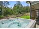 Outdoor hot tub with view of manicured backyard and wooded area at 287 Flower Farm Dr, Acworth, GA 30101