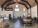 Interior of Qualusi Vineyards tasting room with high ceilings, wood beams, and ample seating for wine tasting events at 287 Flower Farm Dr, Acworth, GA 30101