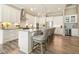 Kitchen features an island with a breakfast bar, granite counters, stainless appliances, and white cabinets at 287 Flower Farm Dr, Acworth, GA 30101