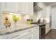 Close up of kitchen details, granite counters, stainless appliances and white cabinets at 287 Flower Farm Dr, Acworth, GA 30101