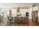 Bright kitchen featuring an island with a breakfast bar, granite counters, stainless appliances, and wood grain tile flooring at 287 Flower Farm Dr, Acworth, GA 30101