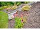Close-up view of vibrant flower garden and rock stairs enhancing the backyard landscape at 287 Flower Farm Dr, Acworth, GA 30101