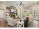 Living room with a stone fireplace, large windows, recessed lights and ceiling fan at 287 Flower Farm Dr, Acworth, GA 30101