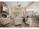 Spacious living room with a stone fireplace, ceiling fan and plenty of natural light at 287 Flower Farm Dr, Acworth, GA 30101