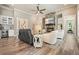Open living room featuring a stone fireplace, and views into the wet bar area at 287 Flower Farm Dr, Acworth, GA 30101
