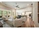 Bright living room with large windows, ceiling fan, views into the kitchen and neutral decor at 287 Flower Farm Dr, Acworth, GA 30101