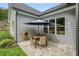 Patio with dining table and umbrella, surrounded by manicured landscaping at 287 Flower Farm Dr, Acworth, GA 30101