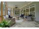 Covered patio with wicker furniture, ceiling fans, string lights, and stone flooring at 287 Flower Farm Dr, Acworth, GA 30101