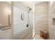 Modern walk-in shower featuring tiled walls, a shower bench, and modern fixtures at 287 Flower Farm Dr, Acworth, GA 30101