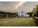 Exterior view of Qualusi Vineyard's event center and tasting room surrounded by fields of grape vines at 287 Flower Farm Dr, Acworth, GA 30101