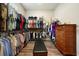 Spacious walk-in closet features custom shelving, wood flooring, and a center bench for added convenience at 287 Flower Farm Dr, Acworth, GA 30101