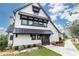 Charming two-story home with black awnings, board and batten siding, and professionally landscaped yard at 3900 Danube Ln, Atlanta, GA 30339