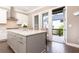 Modern kitchen with white cabinets, island with quartz countertops, and stainless steel appliances and access to the deck at 3900 Danube Ln, Atlanta, GA 30339