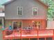 A cozy house featuring a back deck with an outdoor dining set, ideal for gatherings at 4915 Millers Trce, Peachtree Corners, GA 30096