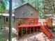 Exterior of home with spacious deck and outdoor seating, set against a backdrop of mature trees at 4915 Millers Trce, Peachtree Corners, GA 30096
