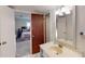 This is a bathroom with white cabinets and a glimpse of a bedroom at 4915 Millers Trce, Peachtree Corners, GA 30096