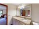 Well-lit bathroom with double sink vanity, granite counters, and large mirror at 4915 Millers Trce, Peachtree Corners, GA 30096