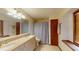 Bathroom features double sink vanity, tiled flooring, and large mirror at 4915 Millers Trce, Peachtree Corners, GA 30096