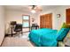Cozy bedroom featuring a ceiling fan, closet and functional desk area at 4915 Millers Trce, Peachtree Corners, GA 30096