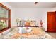 Inviting bedroom featuring a sunny window and bed adorned with stuffed animals at 4915 Millers Trce, Peachtree Corners, GA 30096