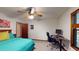 Comfortable bedroom with a ceiling fan, carpeted floors, and natural light from the window at 4915 Millers Trce, Peachtree Corners, GA 30096
