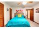 Bedroom featuring a ceiling fan, closet and decoratively-matched bedding at 4915 Millers Trce, Peachtree Corners, GA 30096