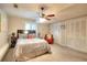This is a bedroom with a ceiling fan, double closets, and natural light at 4915 Millers Trce, Peachtree Corners, GA 30096