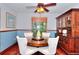 Charming dining area with wood table, built in hutch, blue wallpaper, and bright window at 4915 Millers Trce, Peachtree Corners, GA 30096