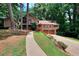 Exterior of home featuring a long driveway, large yard, and a charming two-story facade at 4915 Millers Trce, Peachtree Corners, GA 30096