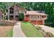 Charming two-story home with lush landscaping, attached garage, and wood accents at 4915 Millers Trce, Peachtree Corners, GA 30096