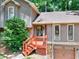Exterior of a home featuring a stone facade and a cozy front porch at 4915 Millers Trce, Peachtree Corners, GA 30096