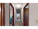 Well-lit hallway with doorways leading to adjacent rooms, and neutral carpeting at 4915 Millers Trce, Peachtree Corners, GA 30096