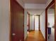 Hallway featuring hardwood floors and multiple doorways leading to various rooms at 4915 Millers Trce, Peachtree Corners, GA 30096