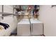 Practical laundry room featuring metal racks for storage, and standard washer/dryer units at 4915 Millers Trce, Peachtree Corners, GA 30096