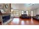 Living room featuring a stone fireplace and window seating in a naturally lit space at 4915 Millers Trce, Peachtree Corners, GA 30096