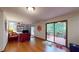 Open-concept living room featuring hardwood floors and a sliding glass door to the back deck at 4915 Millers Trce, Peachtree Corners, GA 30096