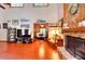 Spacious living room with stone fireplace, vaulted ceilings, hardwood floors, and natural light at 4915 Millers Trce, Peachtree Corners, GA 30096