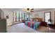 Bright main bedroom with large window, soft carpet and ceiling fan at 4915 Millers Trce, Peachtree Corners, GA 30096